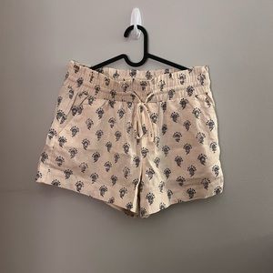 Cream colored shorts with black accent pattern